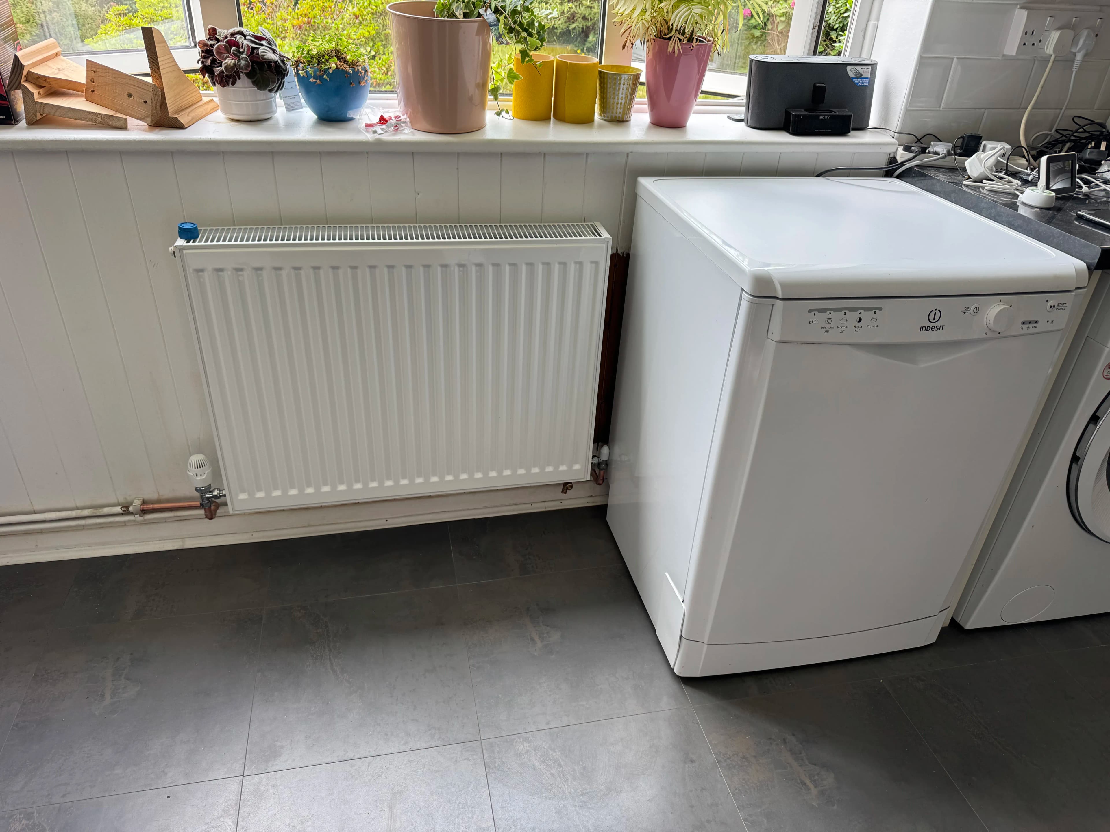 Radiator and appliance plumbing in utility room