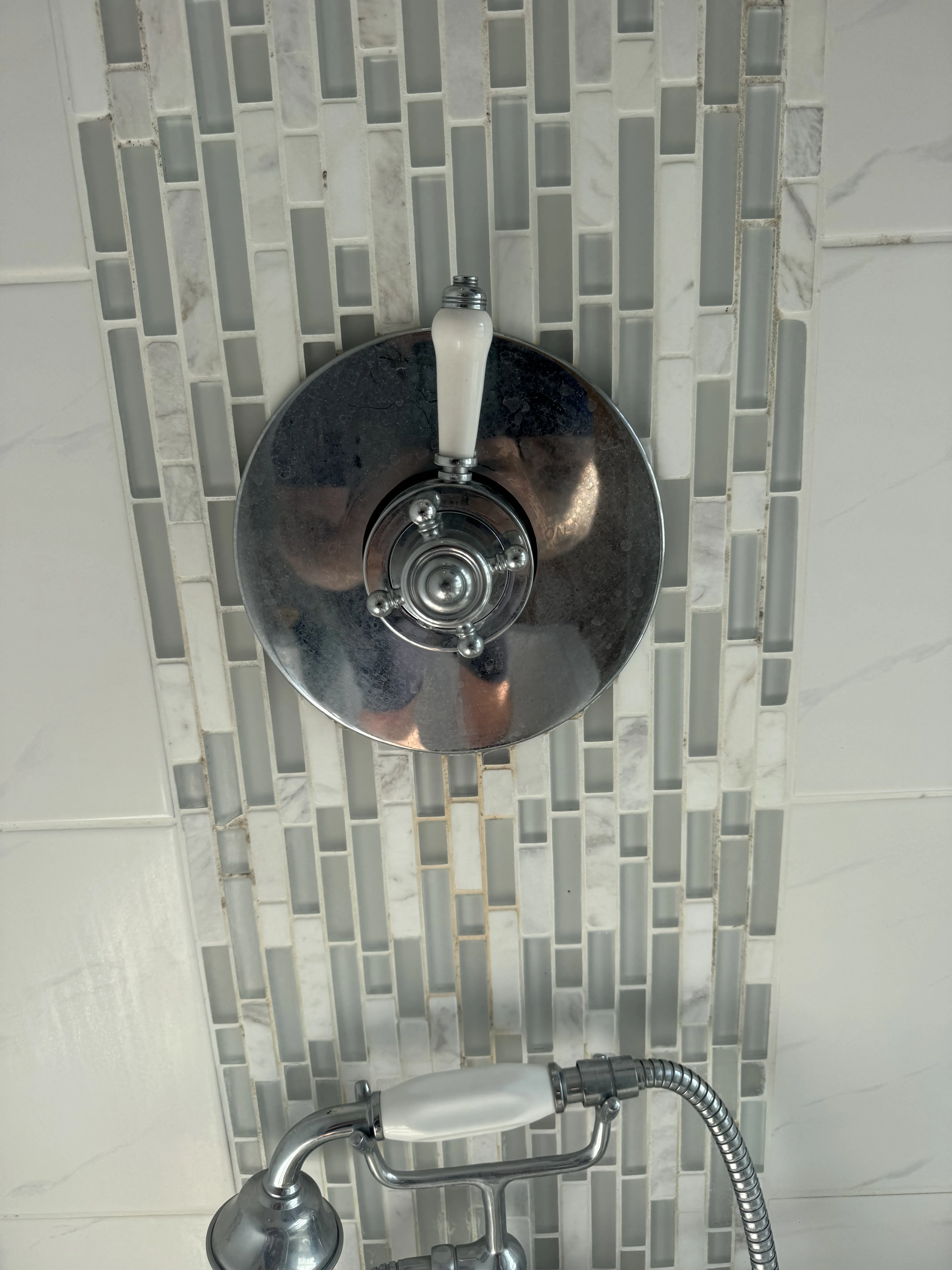 Thermostatic shower valve on mosaic tile feature wall