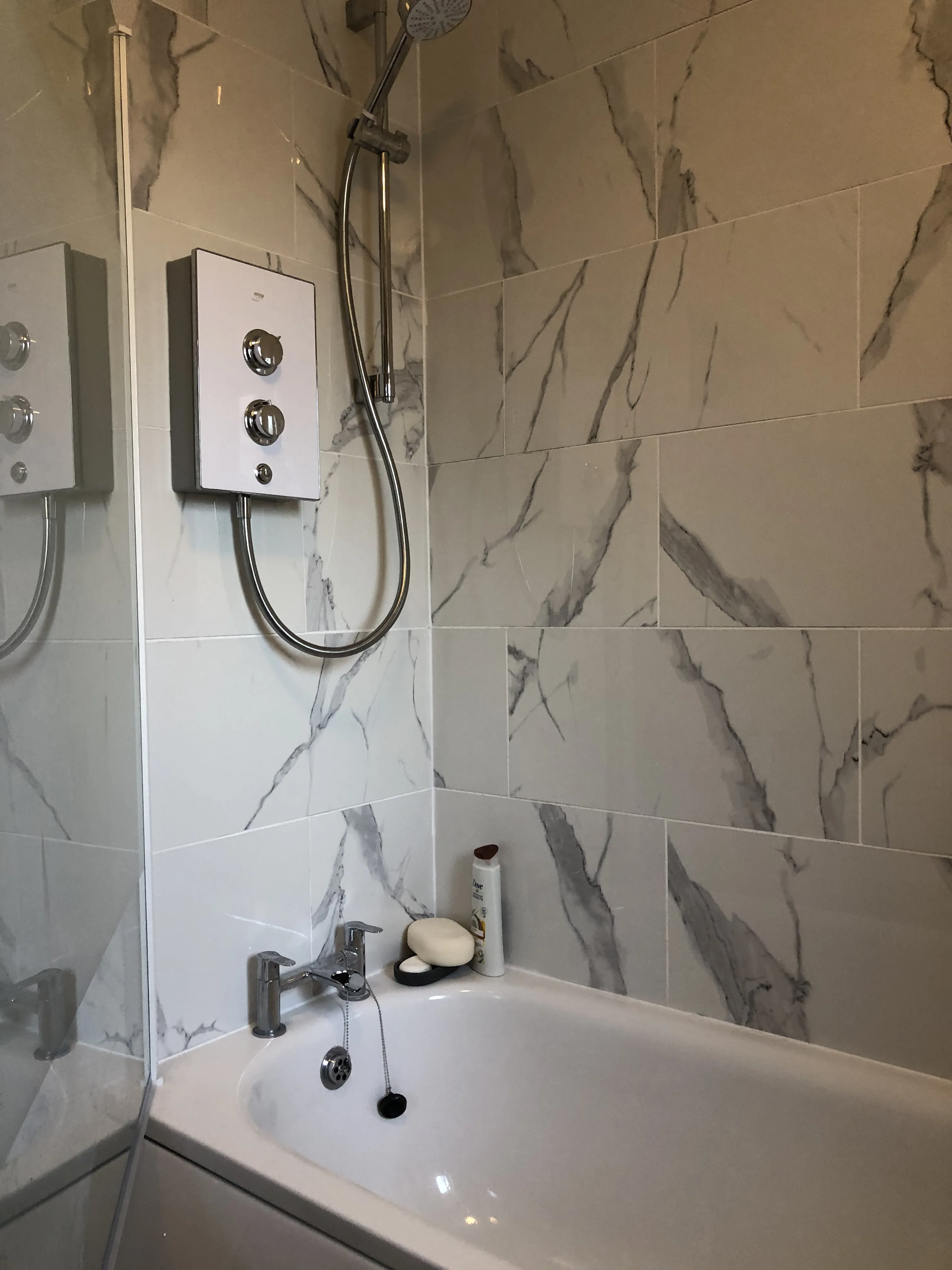 Marble-effect tiled bath with thermostatic shower