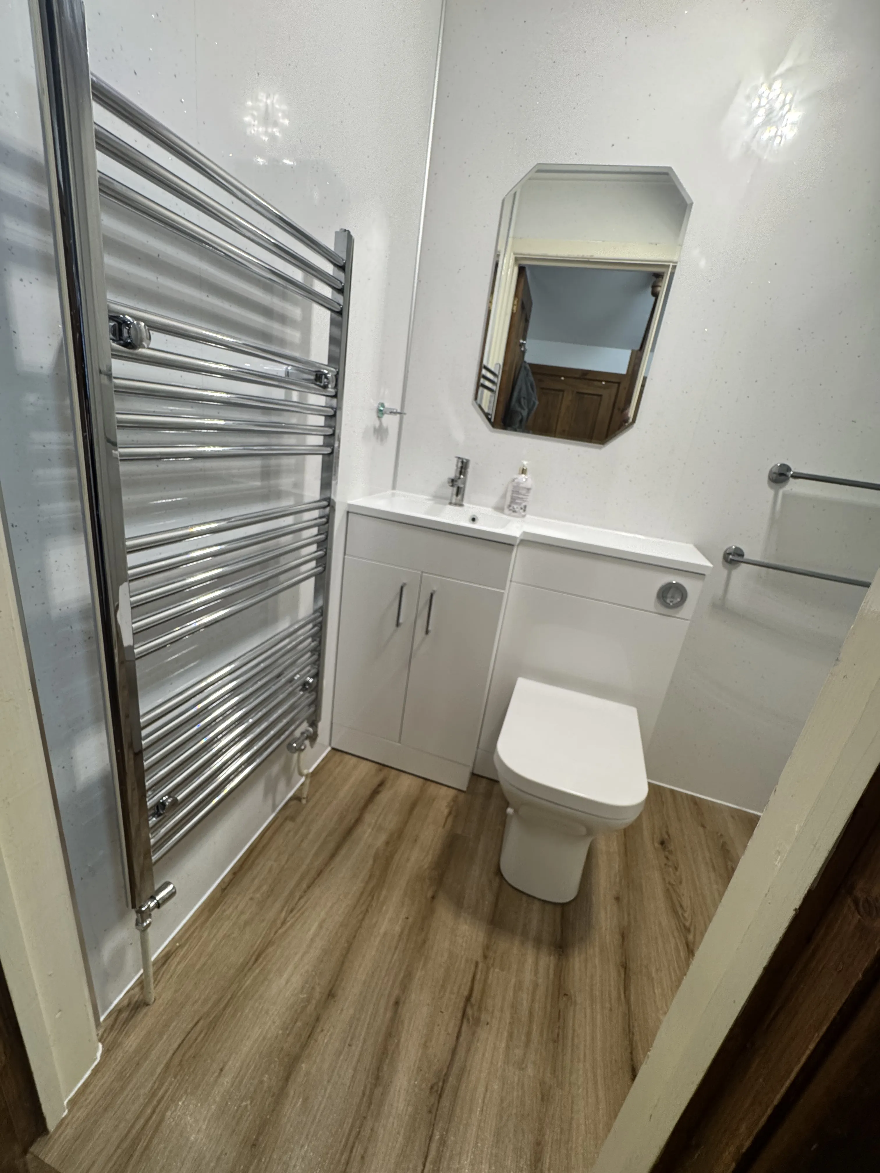Modern white en-suite with heated towel rail